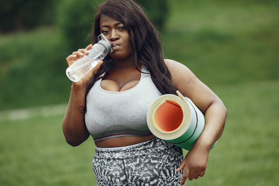 Woman drinking water after a pleasant yoga session